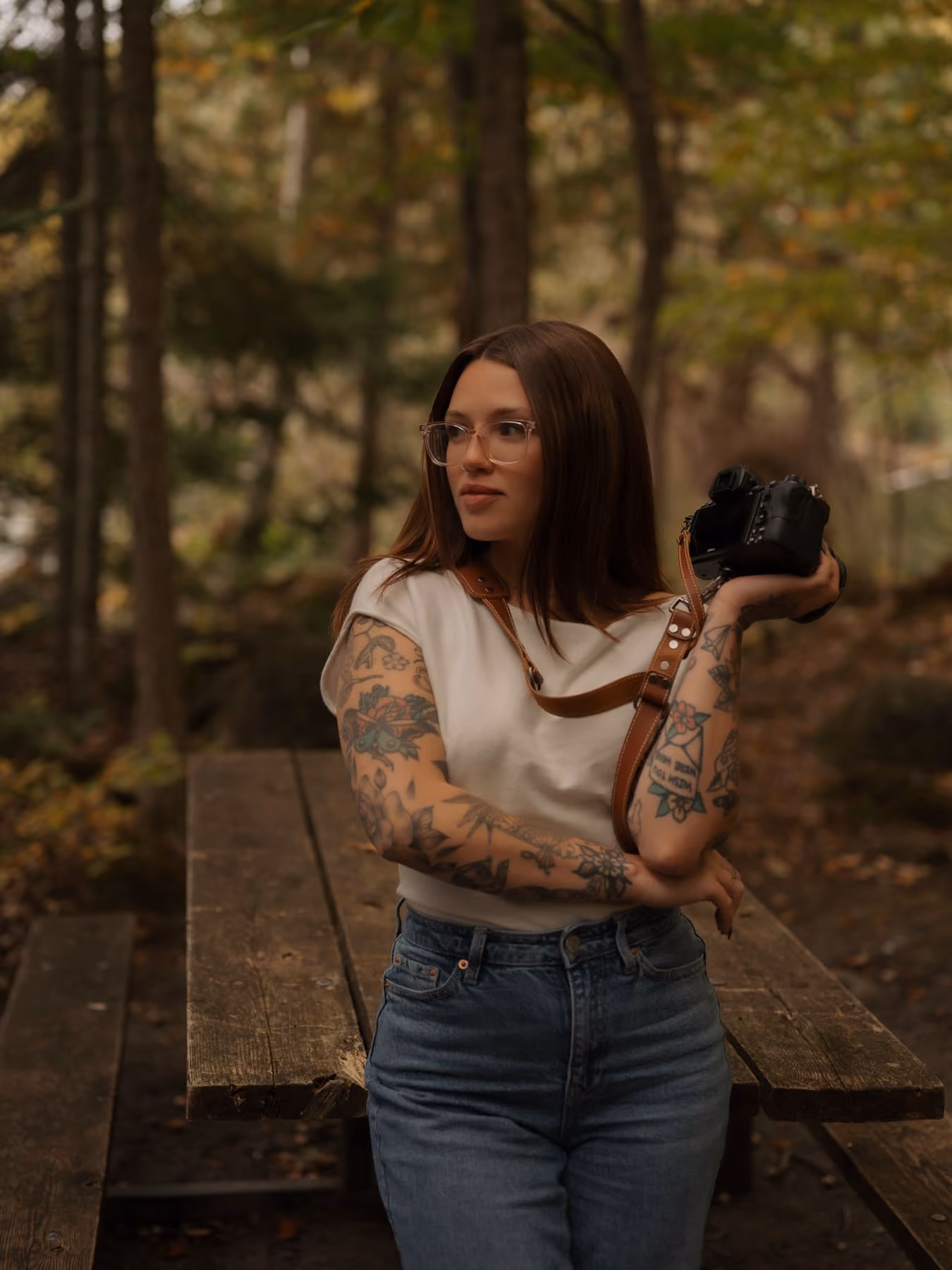 Jordanna Edwards in the woods, holding her camera.